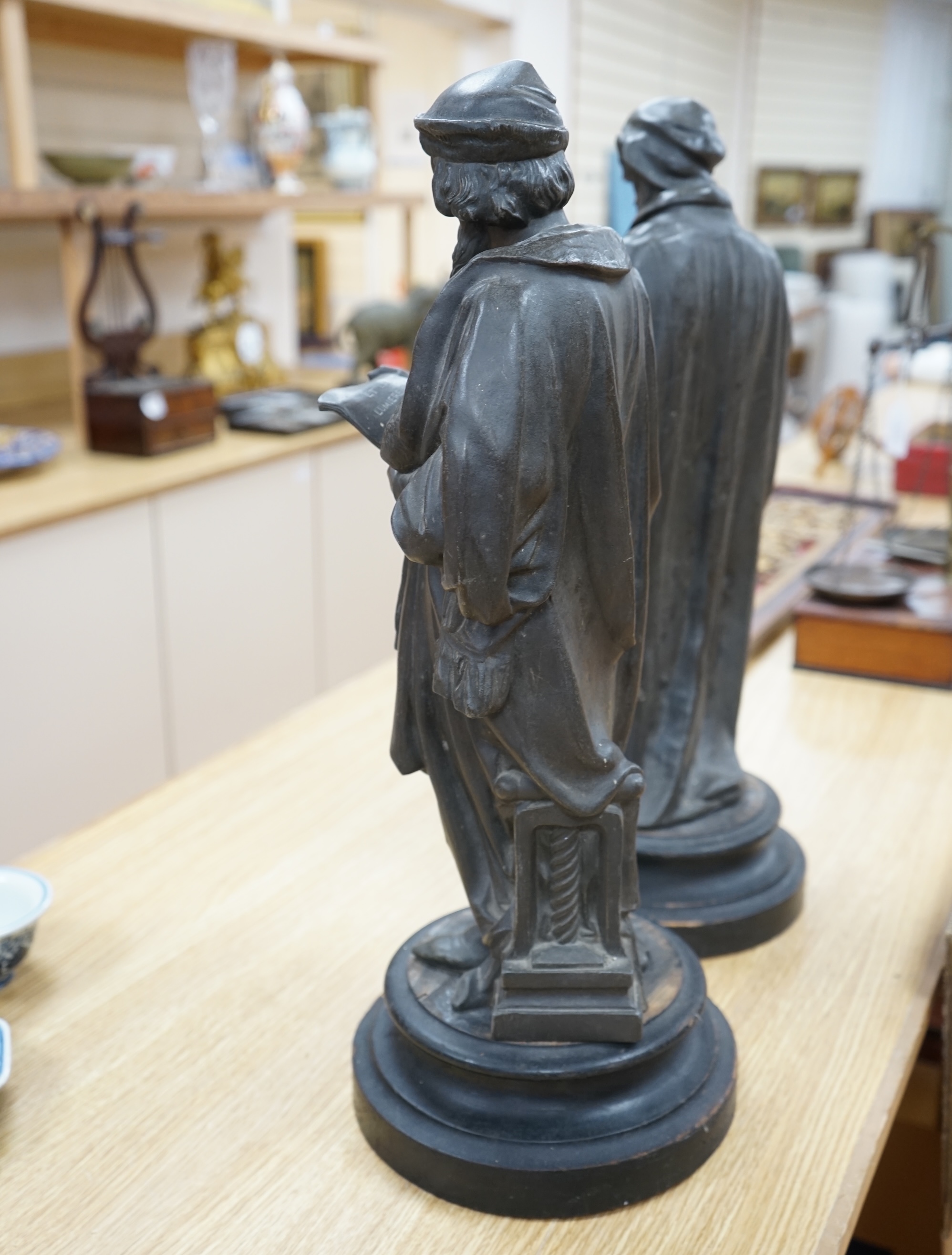 Two bronzed spelter classical figures, possibly Galileo and Leonardo Da Vinci both on turned plinths, 53cm high. Condition - fair, need cleaning plinths need waxing